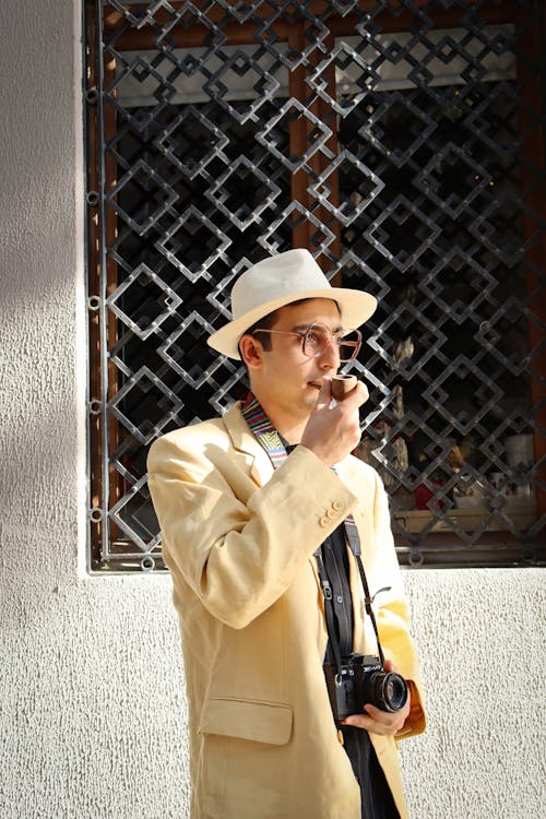 Man in Hat, Eyeglasses and Suit Smoking Pipe