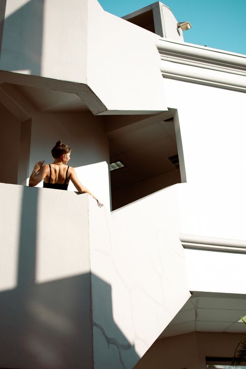 Free A woman observes from a modern architectural structure in St. Petersburg, FL. Stock Photo