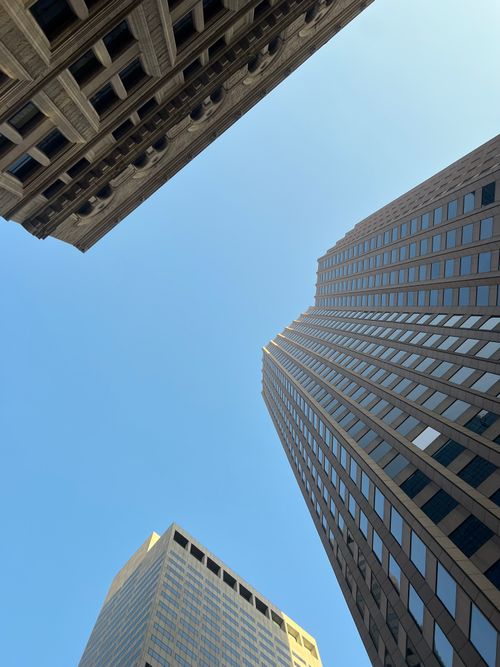Free Low angle view of contemporary skyscrapers against a clear blue sky in an urban district. Stock Photo