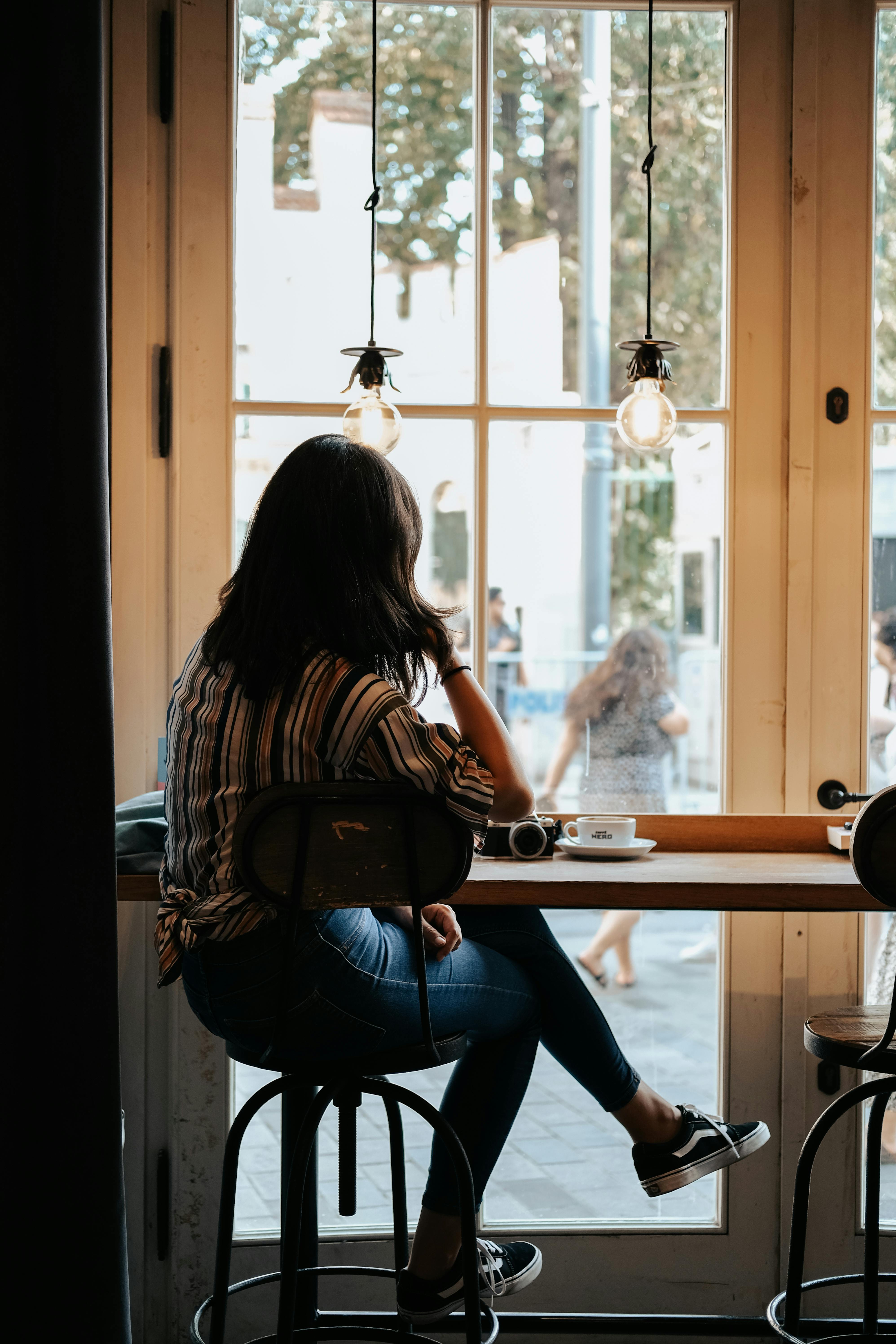 Woman Sitting behind Window · Free Stock Photo