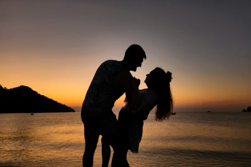 Silhouette of Couple Together on Shore