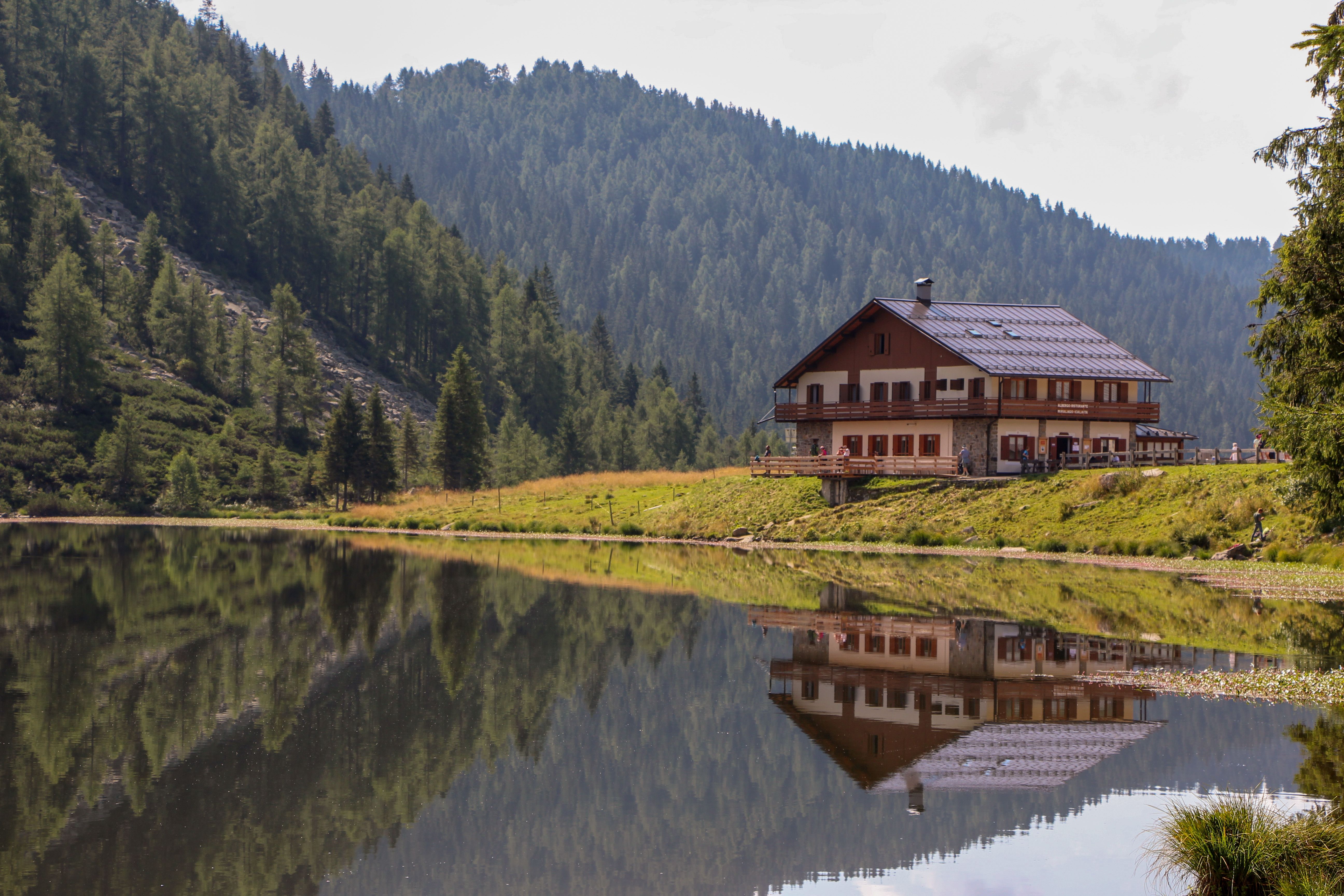 A House by the Lake in Mountains · Free Stock Photo