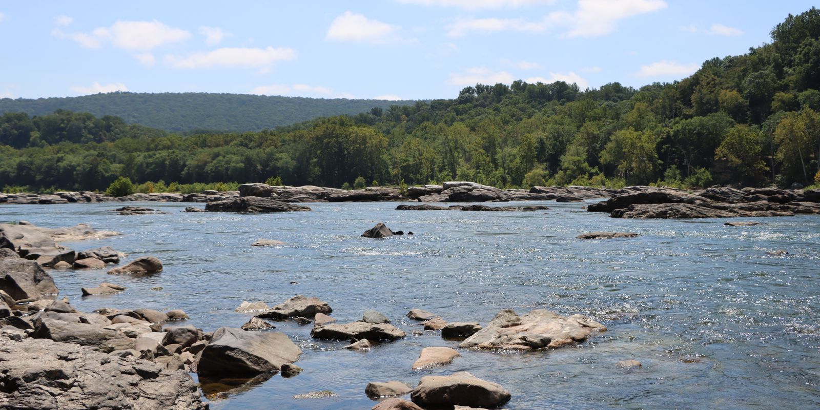 A river winding through green, forested West Virginia hills