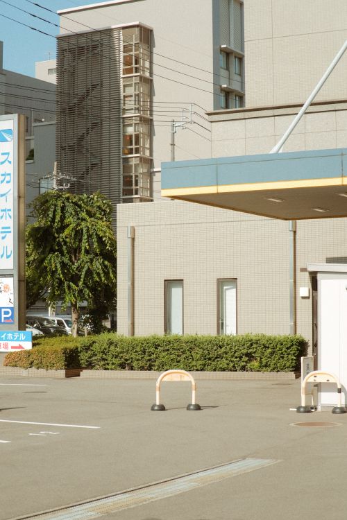 Free A modern urban street scene with contemporary architecture and sunlit buildings. Stock Photo