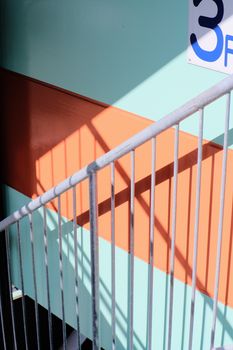 Close-up of a vibrant urban staircase with striking shadows creating a modern design