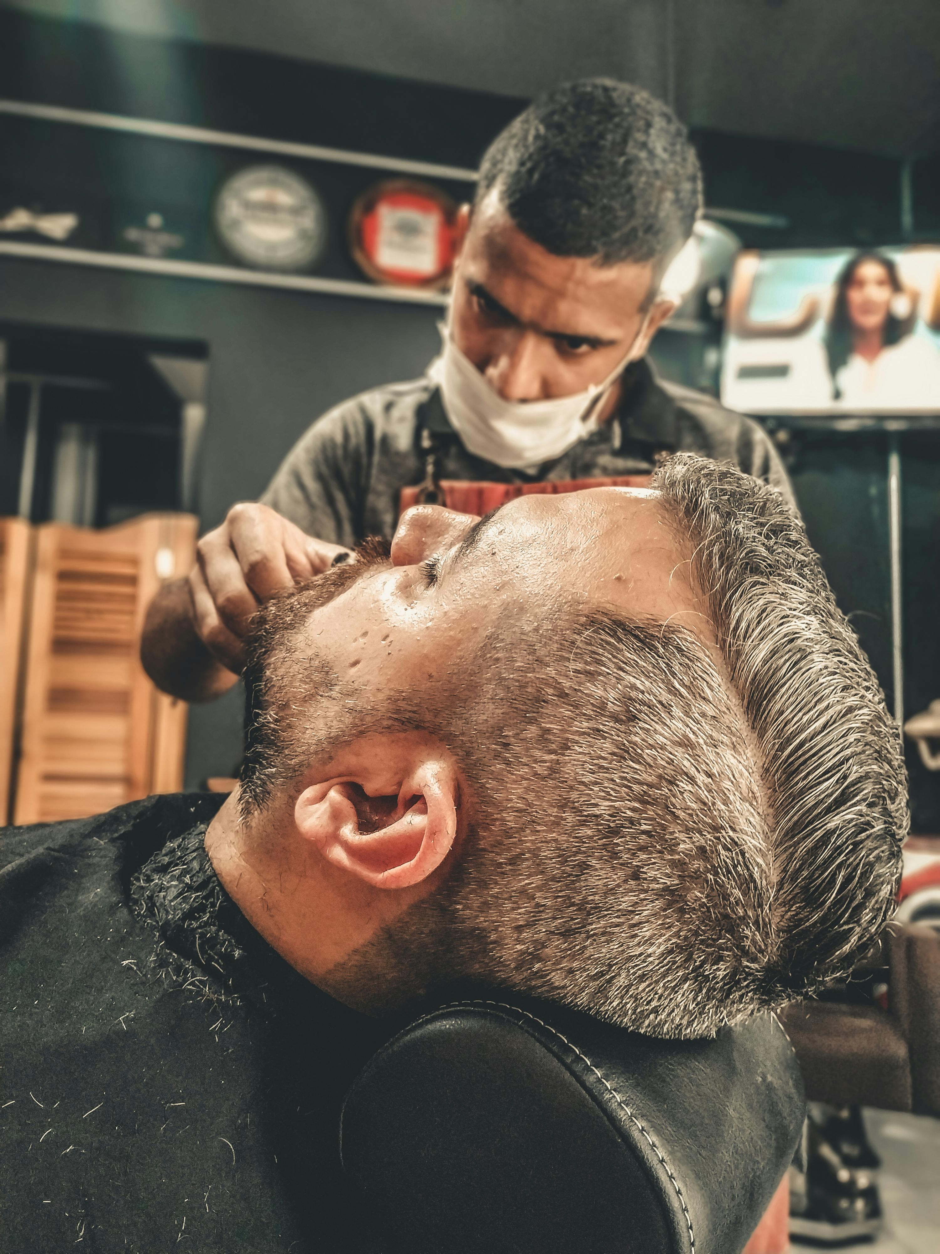 Man Getting His Hair Cut at a Barber Shop · Free Stock Photo