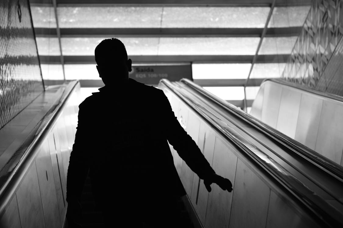 Free Man Walking on Escalator Stock Photo