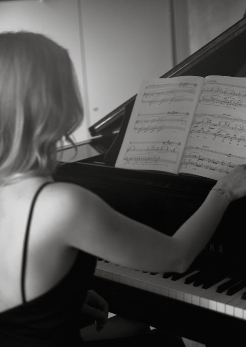 Blonde Woman Sitting at a Piano