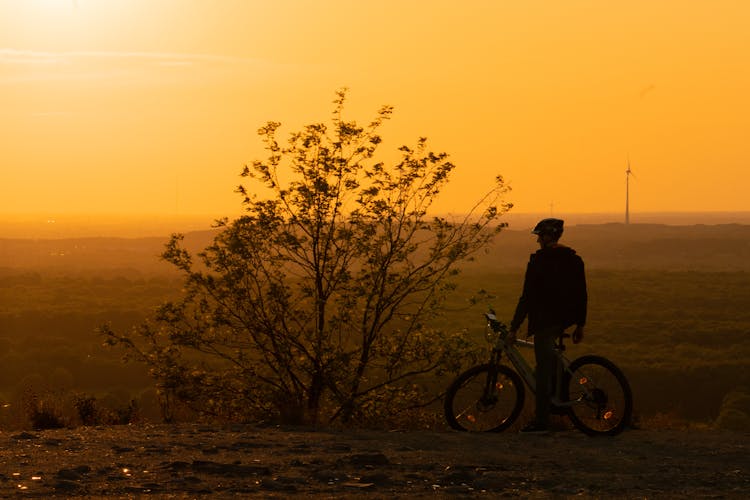 Man On Bike At Sunset