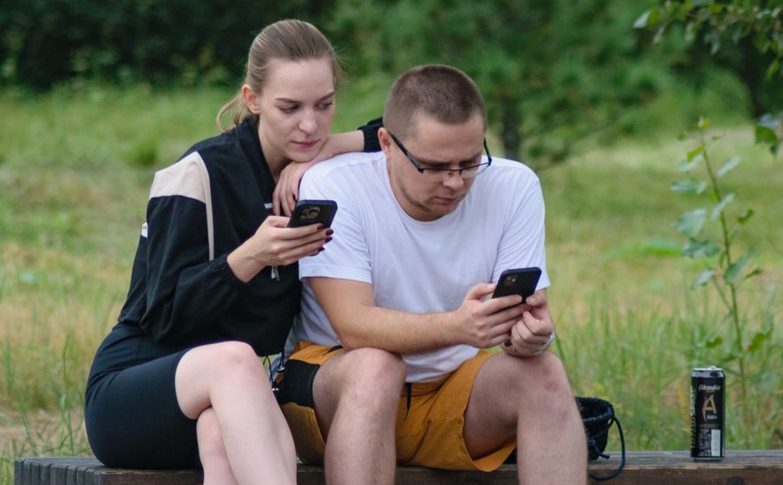 couple looking at dating app on smartphone