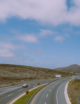Aerial view of a winding highway through the scenic countryside of Ensenada, Mexico.
