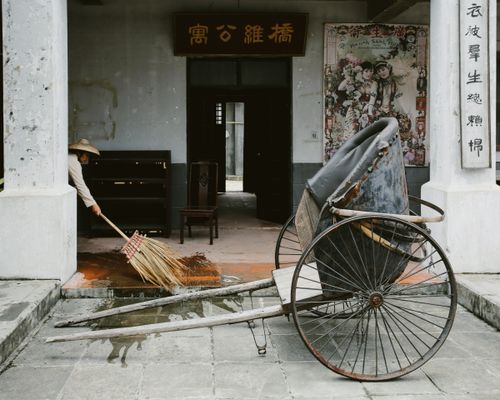 Traditional Sweeper Street Sweeper in a Bamboo Hat Next to Traditional Chinese Rickshaw ...