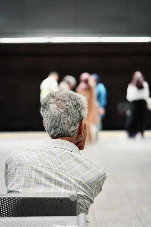 Sitting in Chair Woman Looking at People on Sidewalk