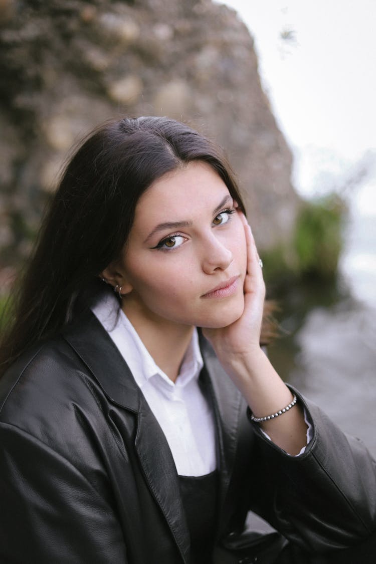 Portrait Of A Young Woman Sitting Outside 