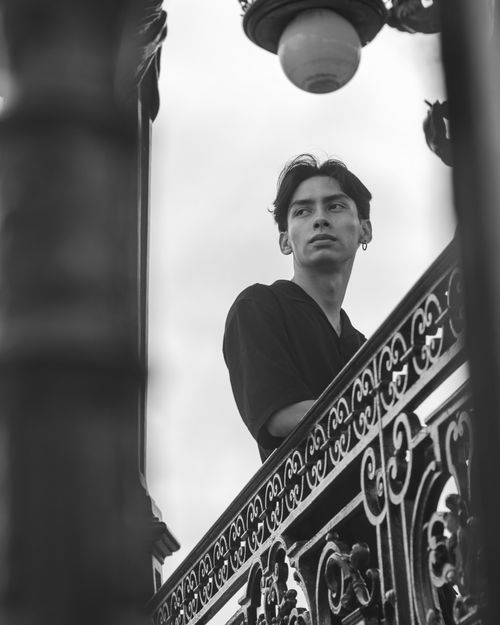 Free Black and white portrait of a young man on a wrought iron balcony in Guadalajara. Stock Photo