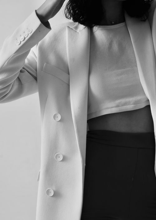 Free A fashionable woman posing in a black and white minimalist style. Perfect for fashion editorials. Stock Photo