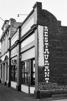 A vintage urban restaurant facade captured in black and white, showcasing its unique architecture.