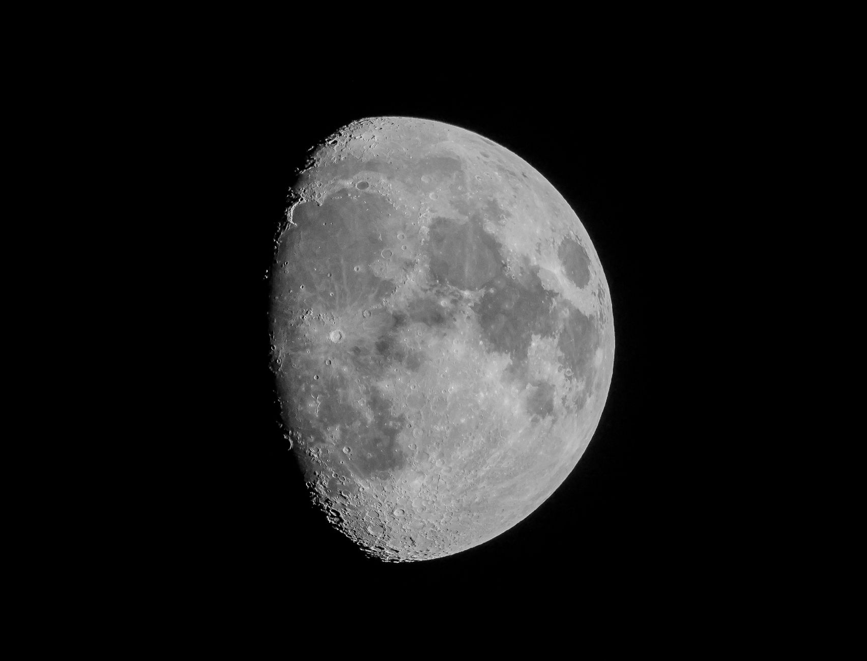 Detailed close-up of the waxing gibbous moon against a black sky, captured in Darien, CT.