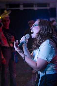 Energetic woman singing at a live music event, capturing audience engagement.
