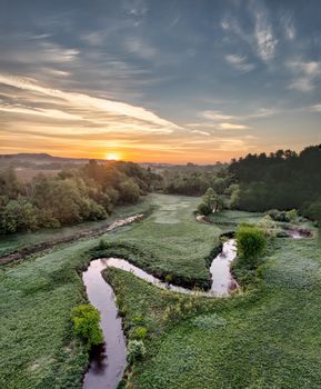 A stunning aerial view of a winding river in Misha Mokwa, WI, at sunset.