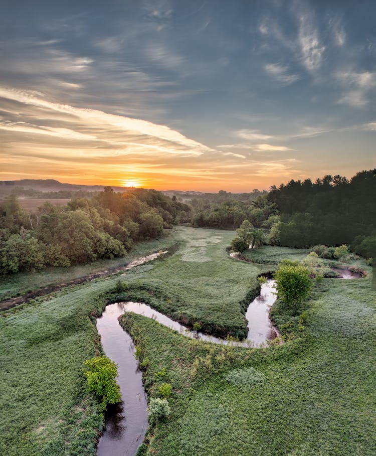 River Bends And Forest On Plains At Sunset