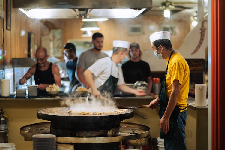 A Man Roasting Food At The Restaurant