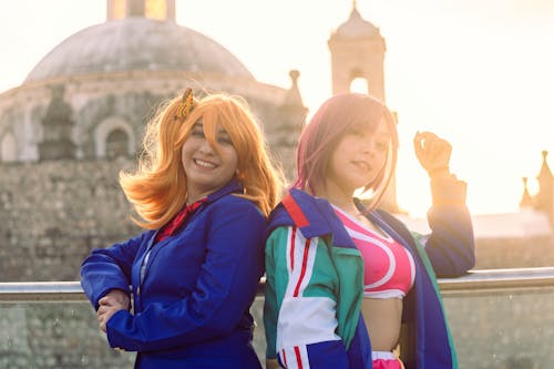 Young Women Standing Outside and Wearing the Mikazuki Shizuka and Honoka Kousaka Cosplays