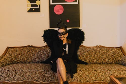 Woman with a Death Mask Sitting on the Sofa