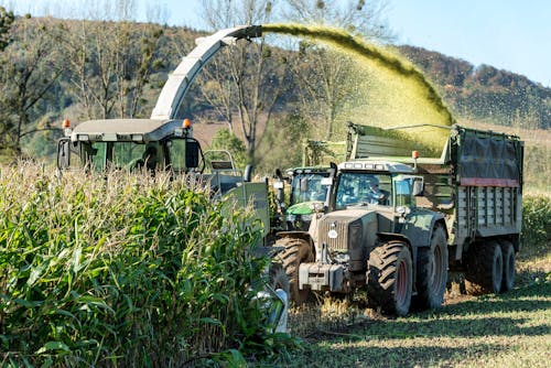 Harvester and Tractor on Field