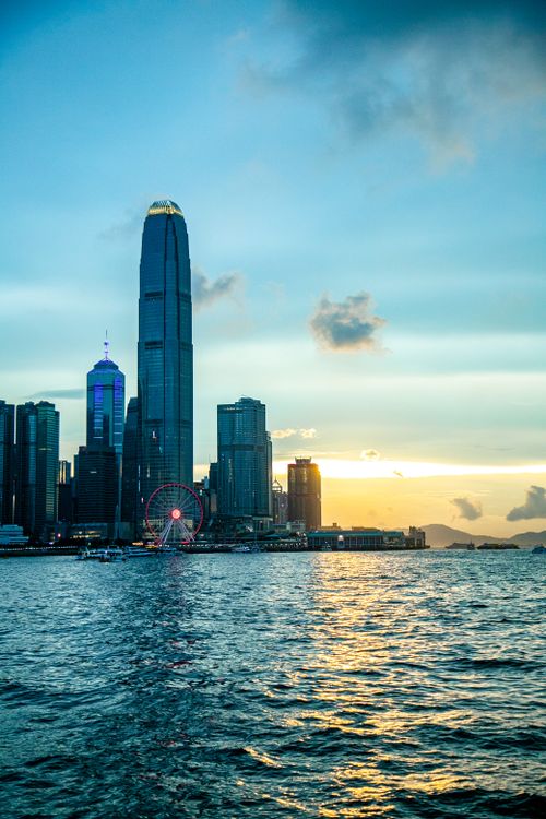 Free Breathtaking view of Hong Kong's skyline with iconic skyscrapers at sunrise over the waterfront. Stock Photo