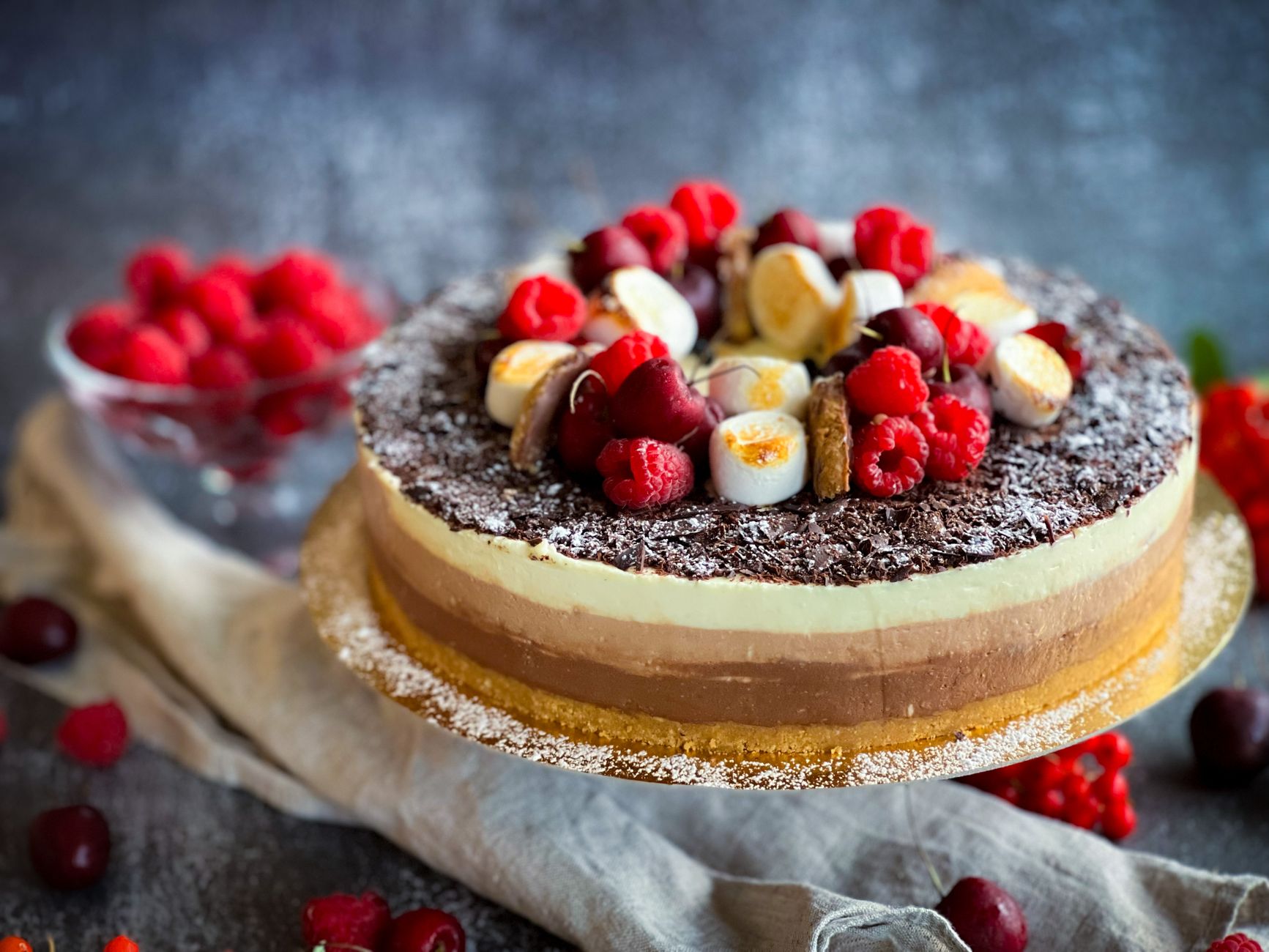 A luscious slice of no-bake vegan cheesecake topped with fresh berries on a rustic plate