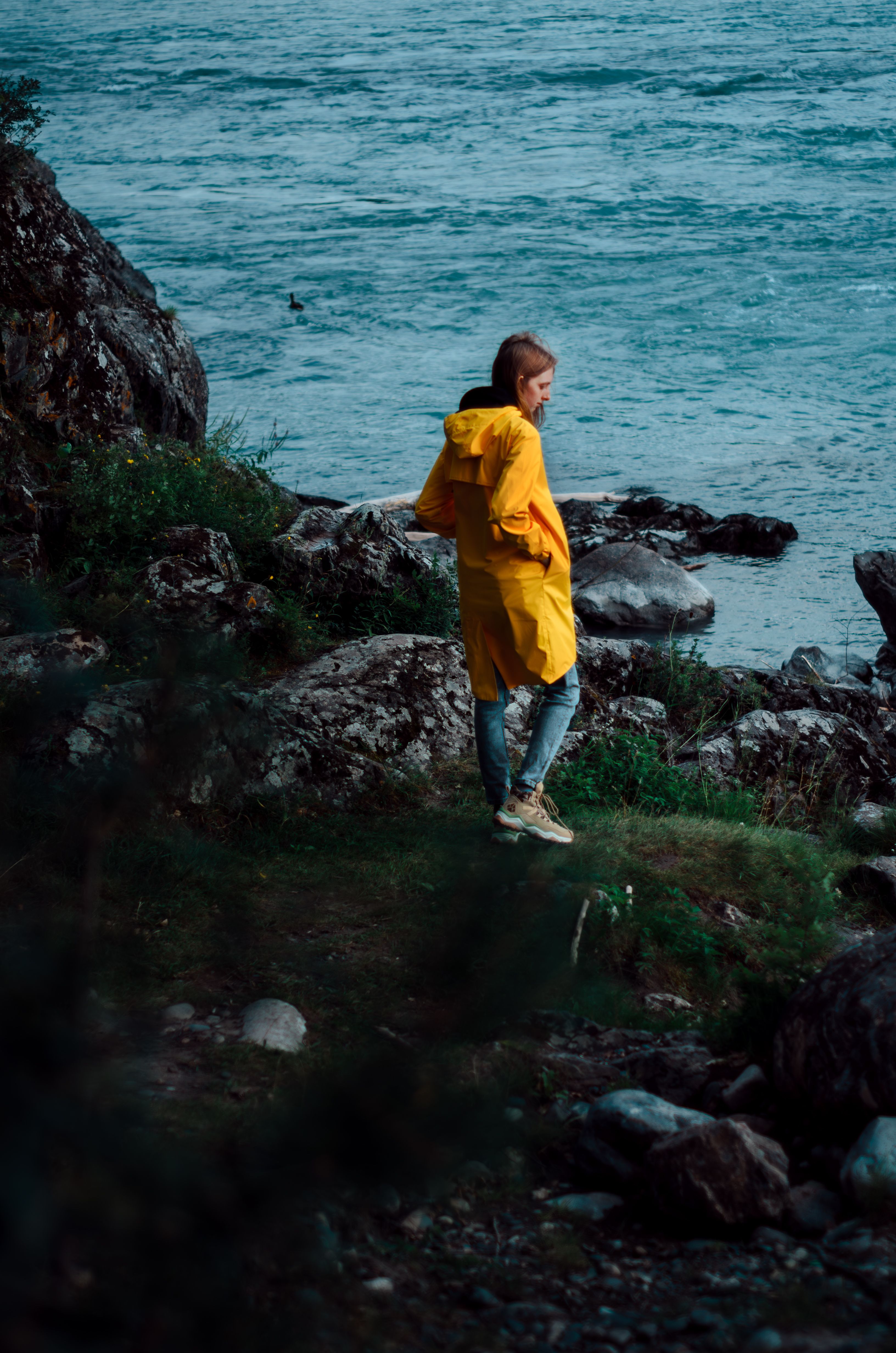 Woman in a Yellow Raincoat Standing on the Seashore · Free Stock Photo
