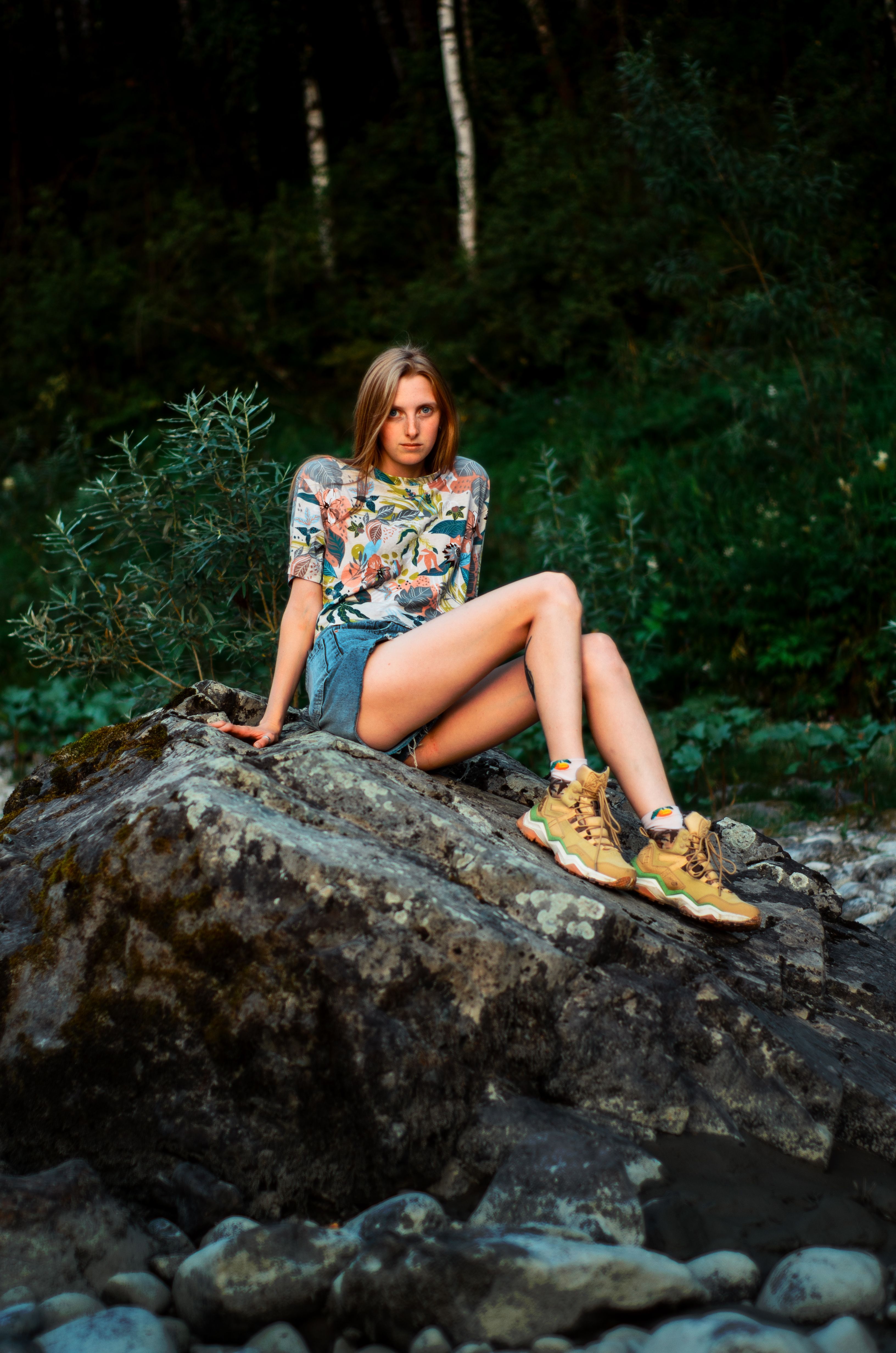 A Woman Sitting on a Large Rock · Free Stock Photo