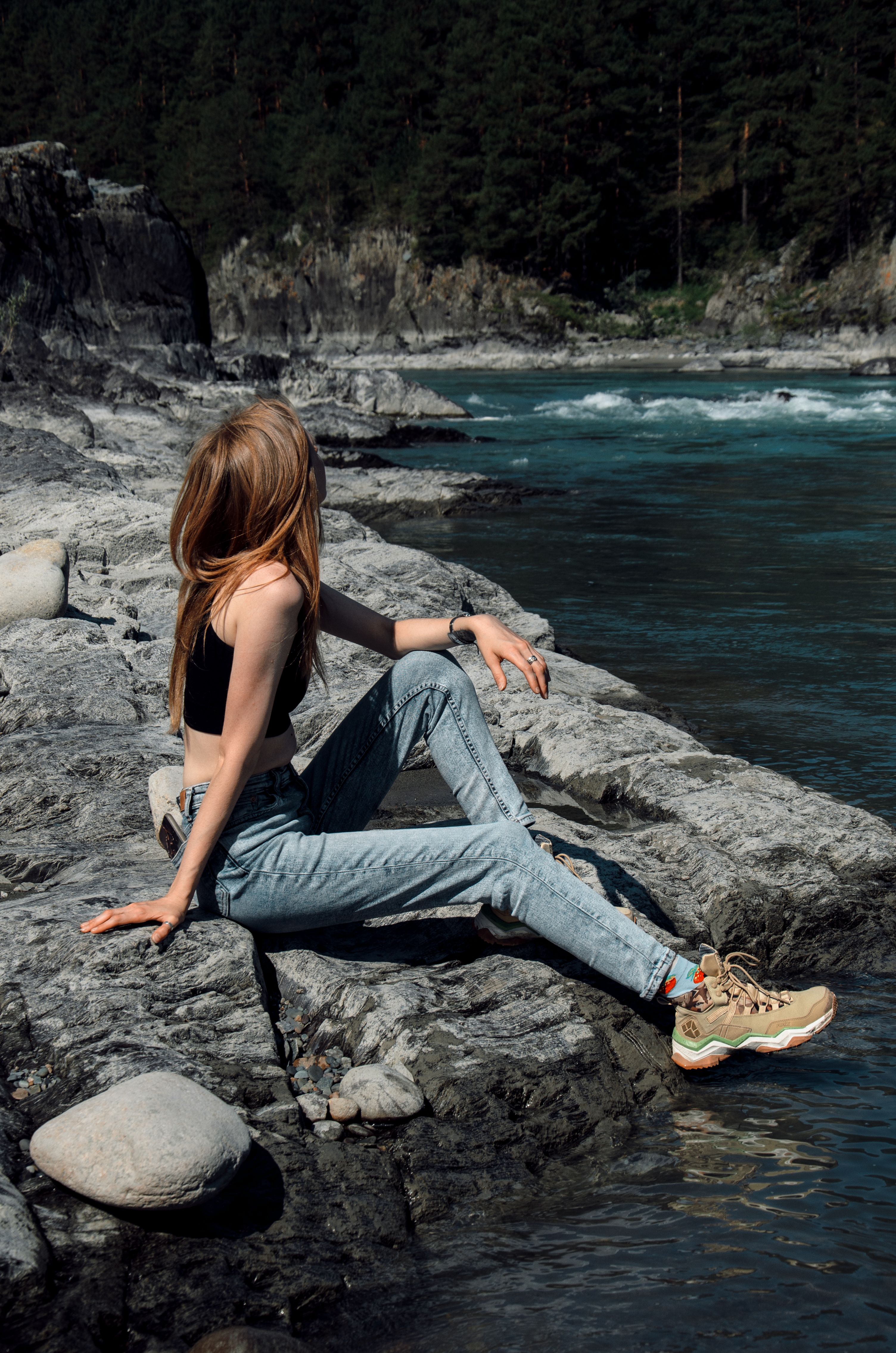 Woman Sitting on a Rock by the Body of Water in Mountains · Free Stock ...