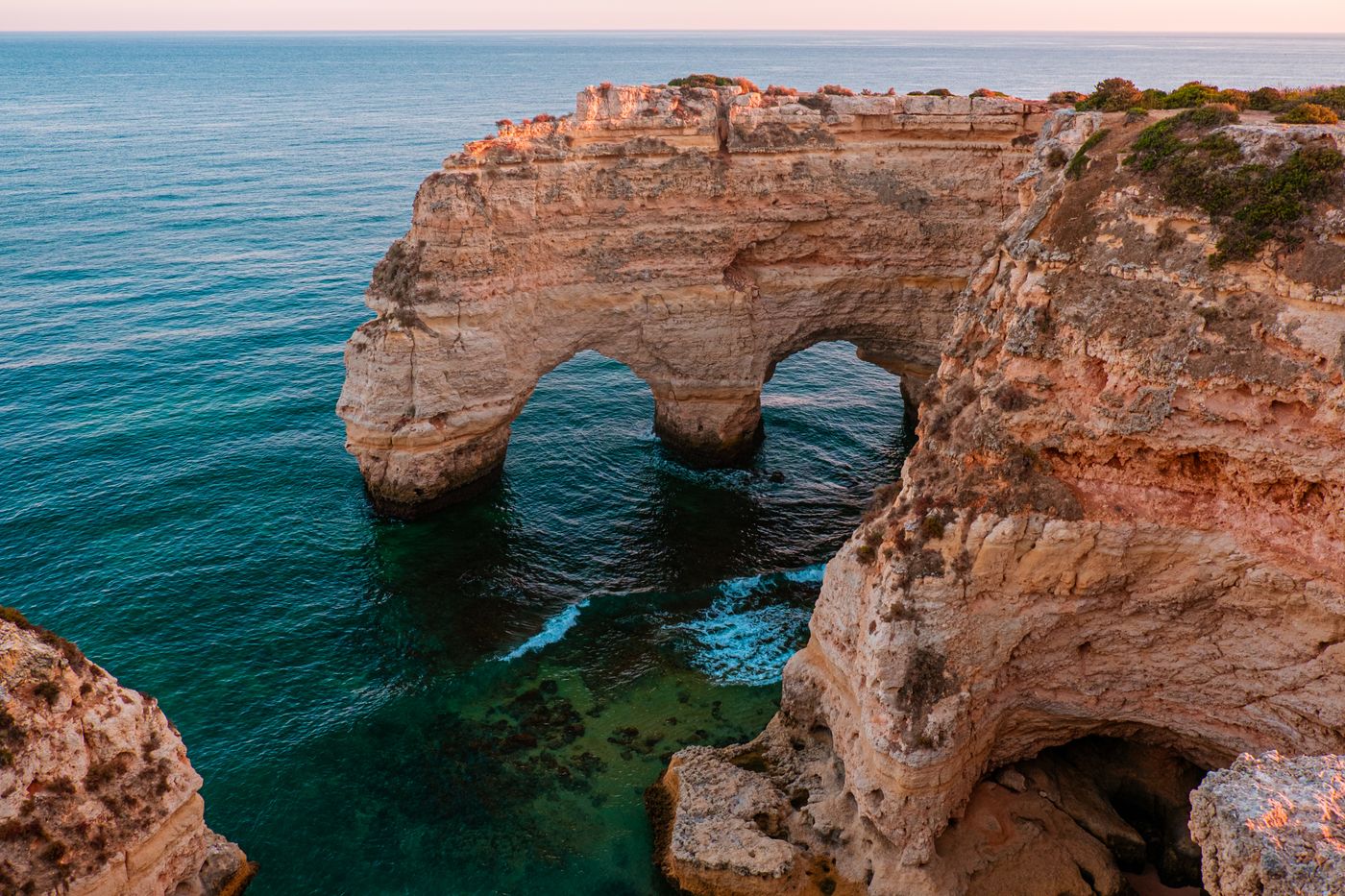 Dramatic sandstone cliffs along the Algarve coastline in Portugal