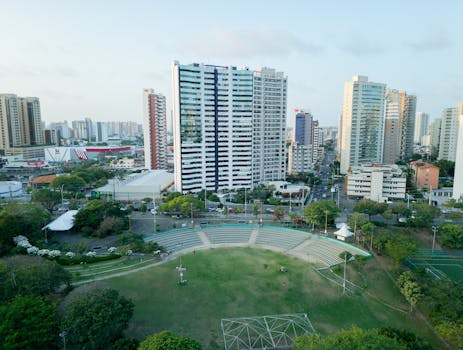 Aerial view of Fortaleza cityscape showing skyscrapers, parks, and urban greenery.