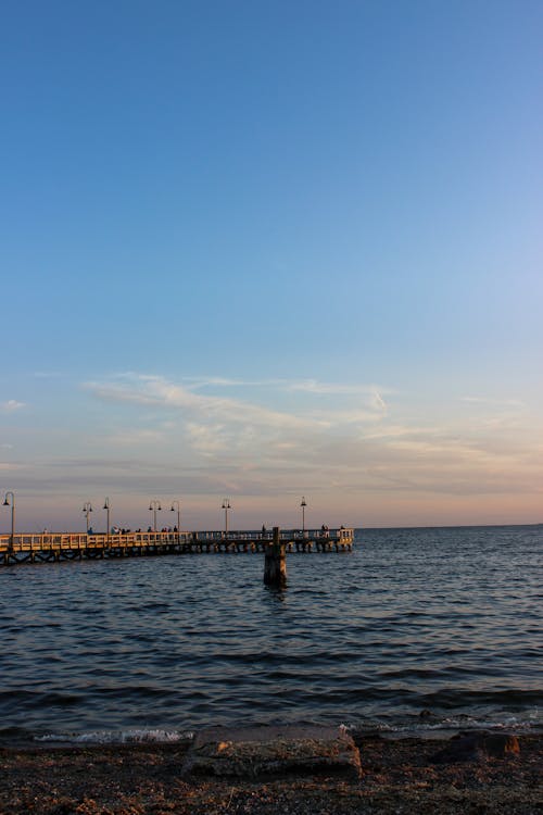View of a Pier on the Seashore at Sunset 