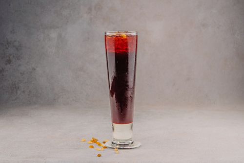 Free A refreshing red berry cocktail in a tall glass, perfect for a cool beverage on a gray background. Stock Photo