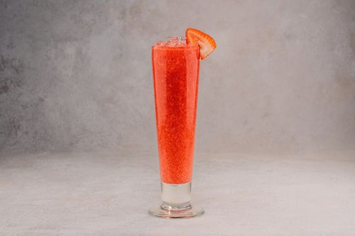 Free Tall glass of strawberry cocktail with ice, perfect for refreshing summer treats in a studio setting. Stock Photo