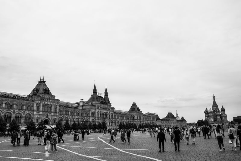 A black and white photo of Moscow's iconic Red Square with GUM and Saint Basil's Cathedral.