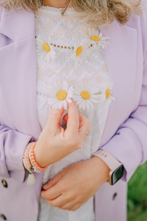 Woman in Suit Holding Daisies