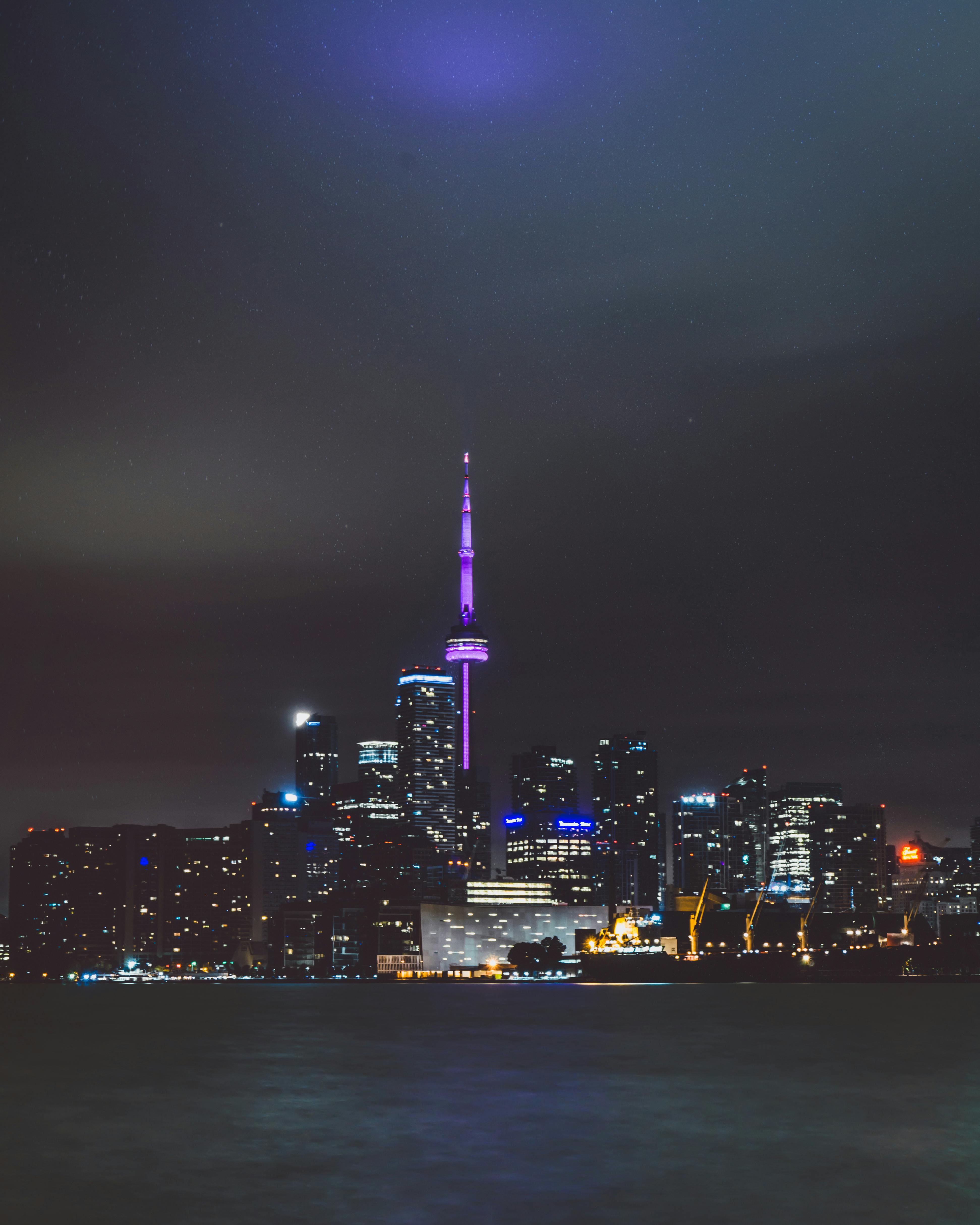 Illuminated Cityscape Against Blue Sky At Night · Free Stock Photo