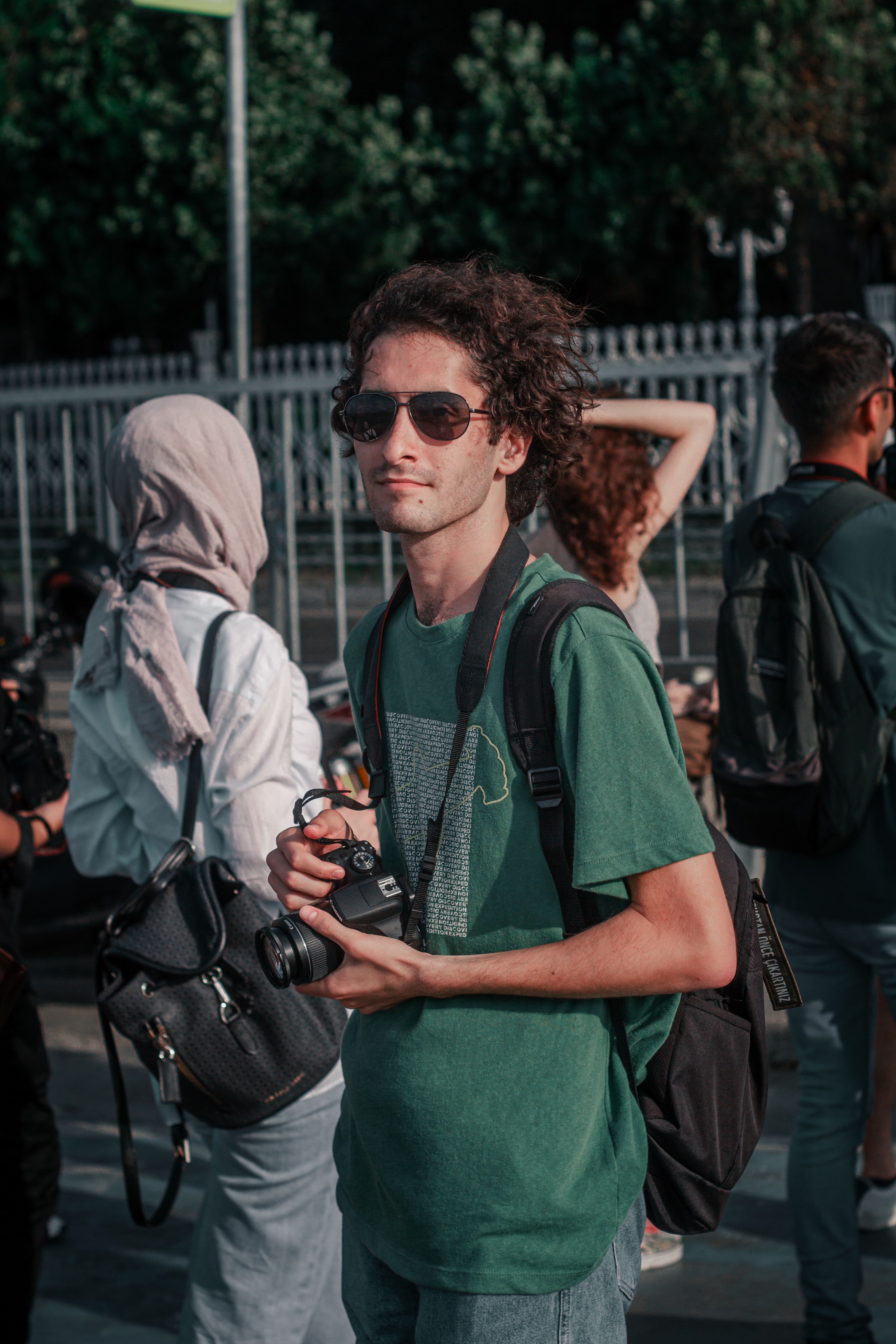 Man with Camera Standing among People · Free Stock Photo