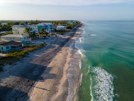 Aerial View of Waves Washing Up the Beach near Houses and Palm Trees