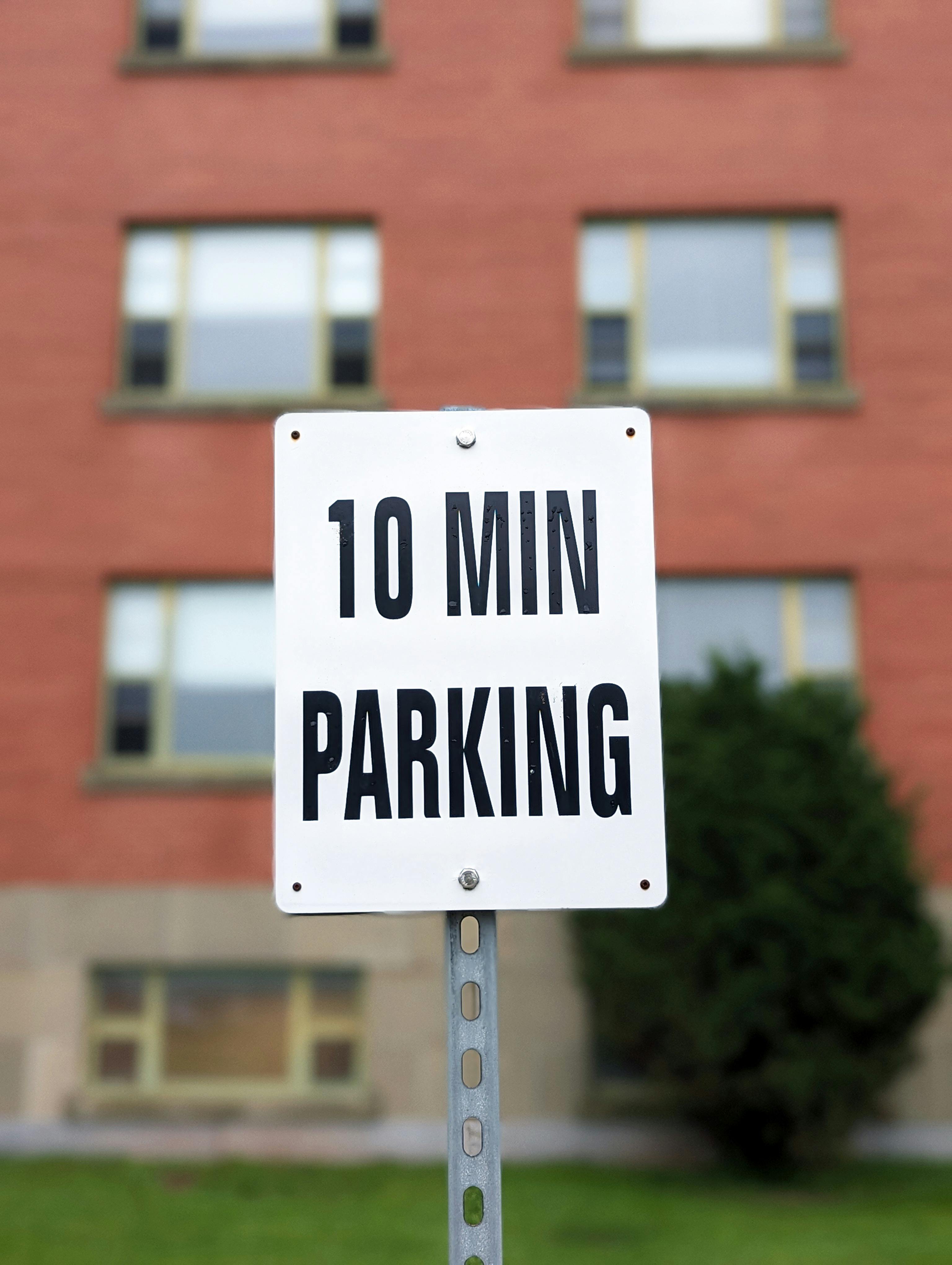 Close-up of a '10 Min Parking' sign in front of a building in Truro, NS, Canada.