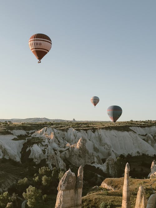 Hot Air Balloons Flying under Clear Sky in Cappadocia