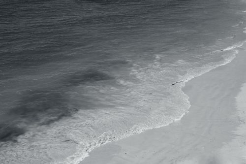 Free A captivating aerial view of waves gently washing over the sandy shore in Albufeira, Portugal. Stock Photo