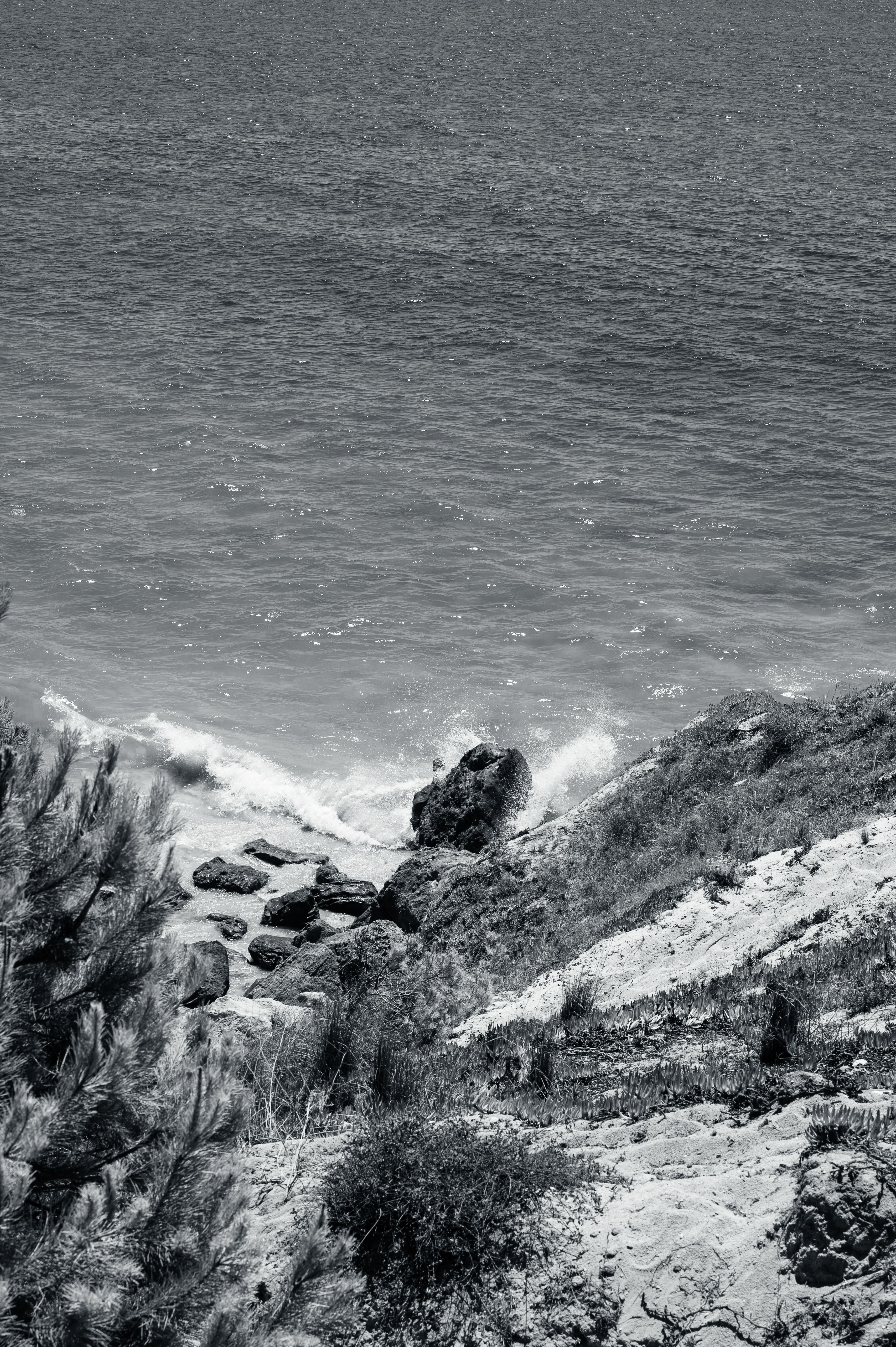 Black and White Photo of Waves Crashing on a Rocky Shore · Free Stock Photo