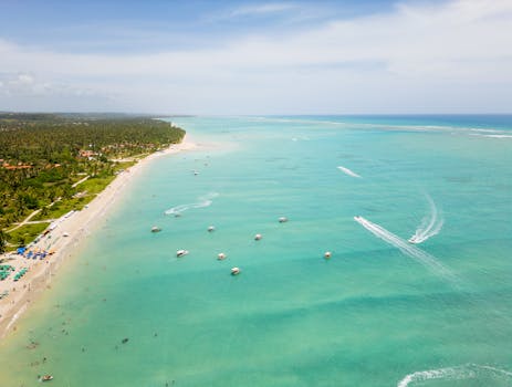 Experience the breathtaking aerial view of Antunes Beach with turquoise waters and a vibrant coastline in Brazil.