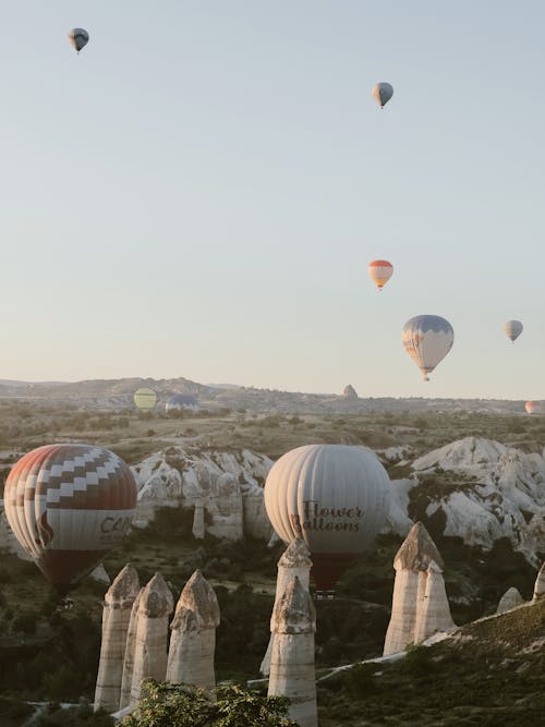 Hot Air Balloons Flying over Rock Formations in Cappadocia